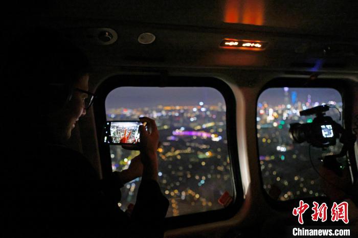 6月3日晚，游客乘坐上海新空直升機(jī)有限公司直升機(jī)開(kāi)啟鳥(niǎo)瞰黃浦江空中圓夢(mèng)之旅，并用手機(jī)拍攝城市夜景?！∫罅⑶?攝