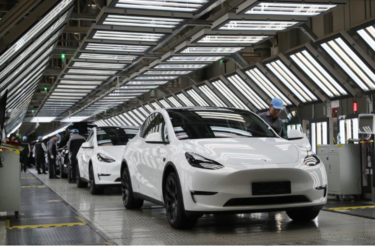 2023年12月22日，在特斯拉上海超級工廠內(nèi)，工人在對出廠前的車輛進行漆面及門窗檢測。新華社記者 方喆 攝