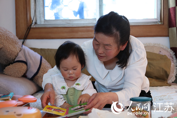 王繼蓮帶孫女看童書。人民網(wǎng) 冷金明攝