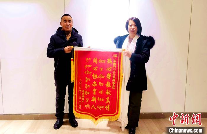 圖為聶榮縣完全小學(xué)向西藏高山文化發(fā)展基金會贈送錦旗?！∮谫e 攝