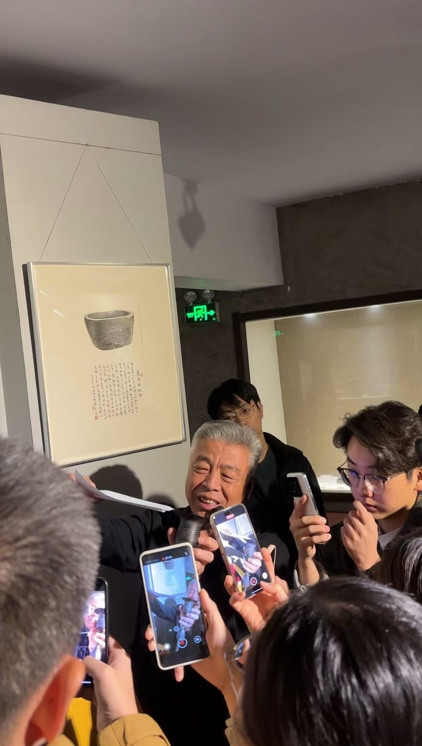 黑陶邢文化博物館館長邢葆東展示兩張相疊的A4紙，向記者解釋此為杯口的厚度。