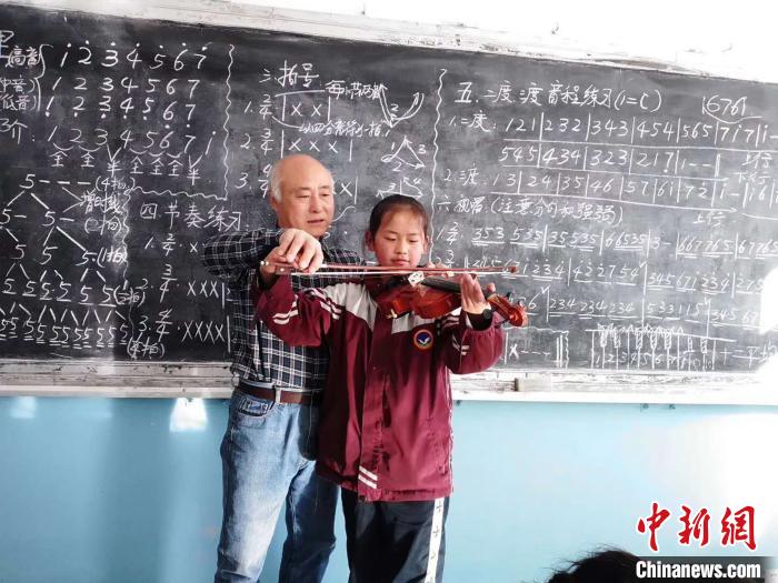 圖為趙興洲教學(xué)生拉小提琴。受訪者提供