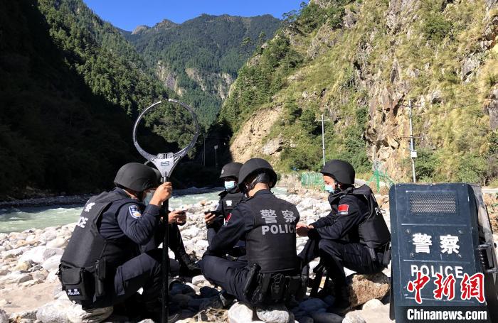 圖為西藏吉隆出入境邊防檢查站移民管理警察在中尼邊境巡邏途中收看二十大開幕直播。　郭章統(tǒng) 攝